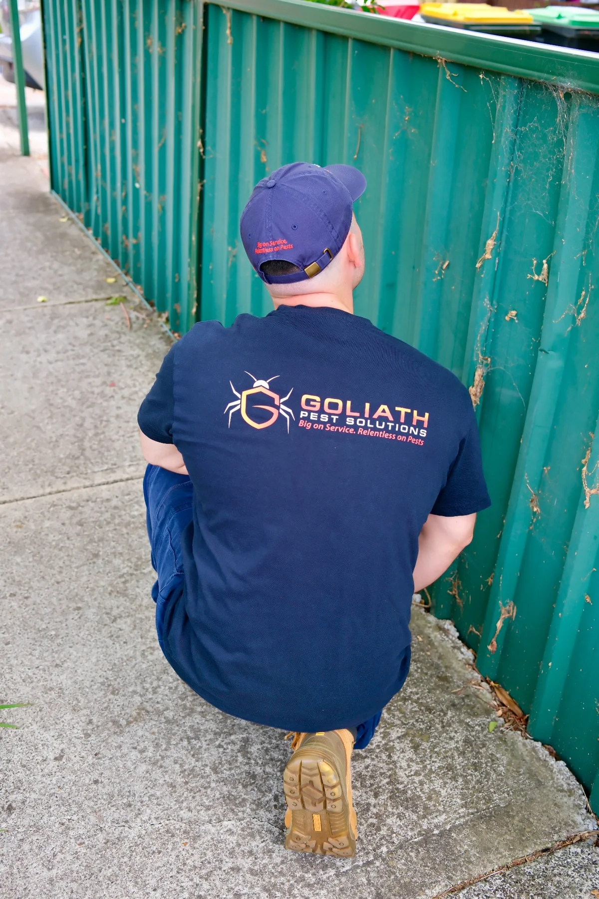 Back of Goliath Pest Solutions uniform during site work