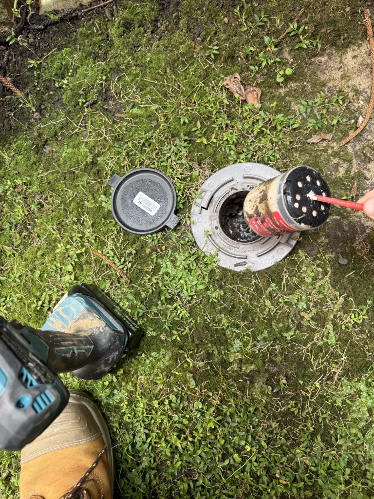 Pest treatment equipment and circular fittings arranged on a grass lawn