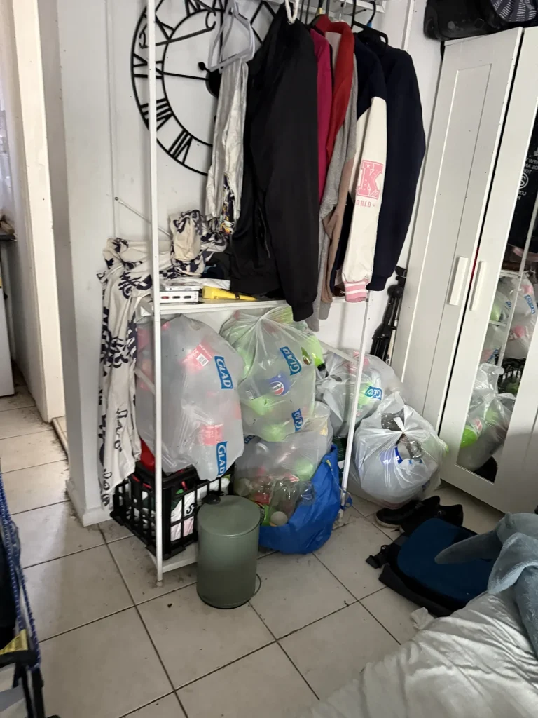 Clutter and stored items observed in a small interior room