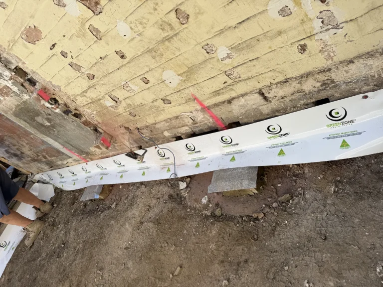 Close-up of protection strip fastened beside timber and subfloor framing