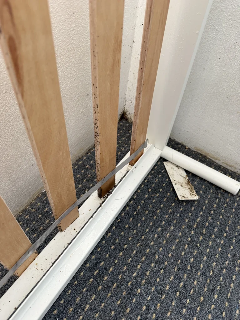 Exposed timber near an internal doorway with visible damage