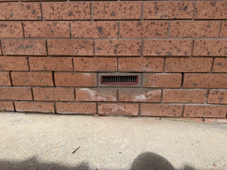 Second view of the brick ventilation opening and external wall base