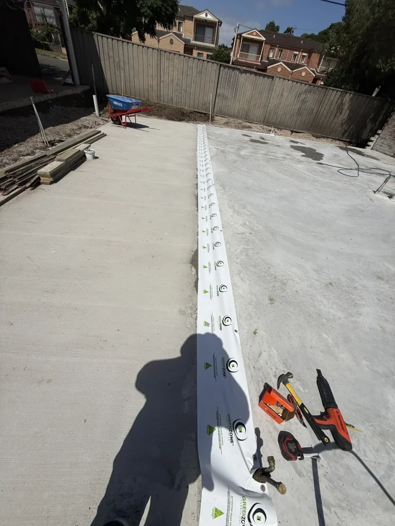 Construction slab perimeter with alignment strip and tools