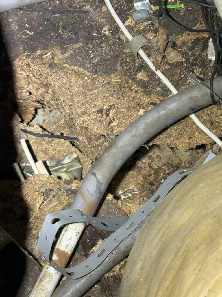 Close-up of a hose and work area below a low floor