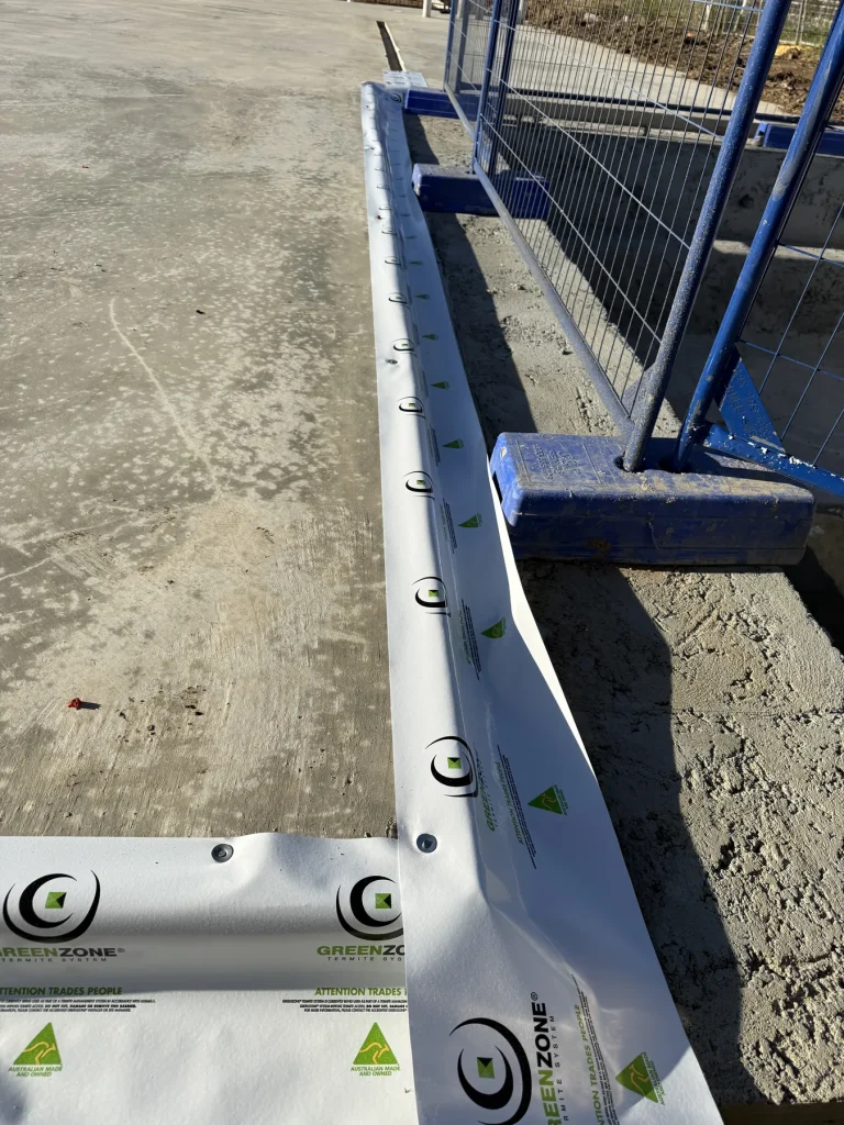 Close-up of perimeter barrier strip fixed beside slab edge