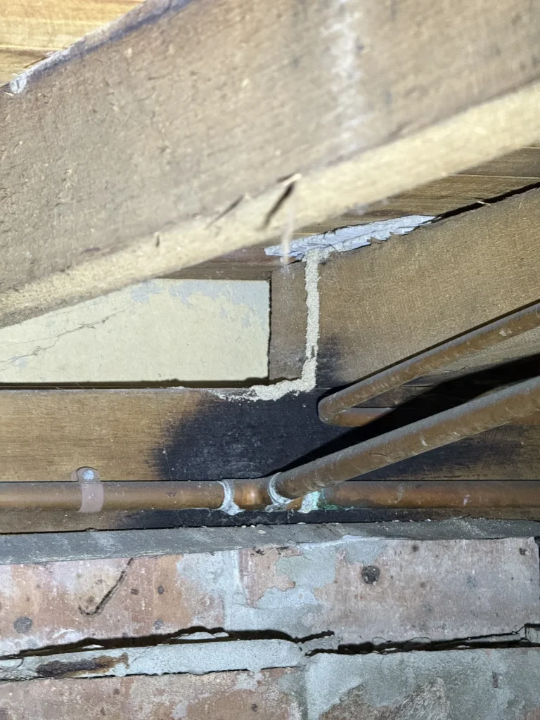 Subfloor foundation junction inspected for termite entry risk