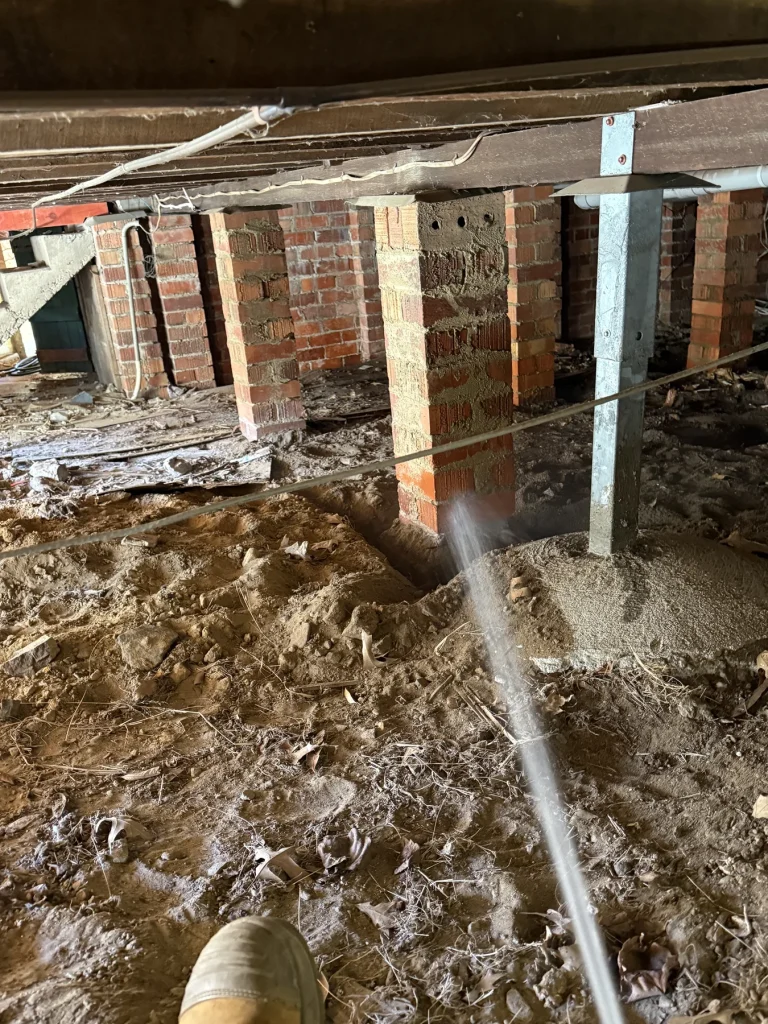Pest-control treatment around foundation piers in a crawlspace
