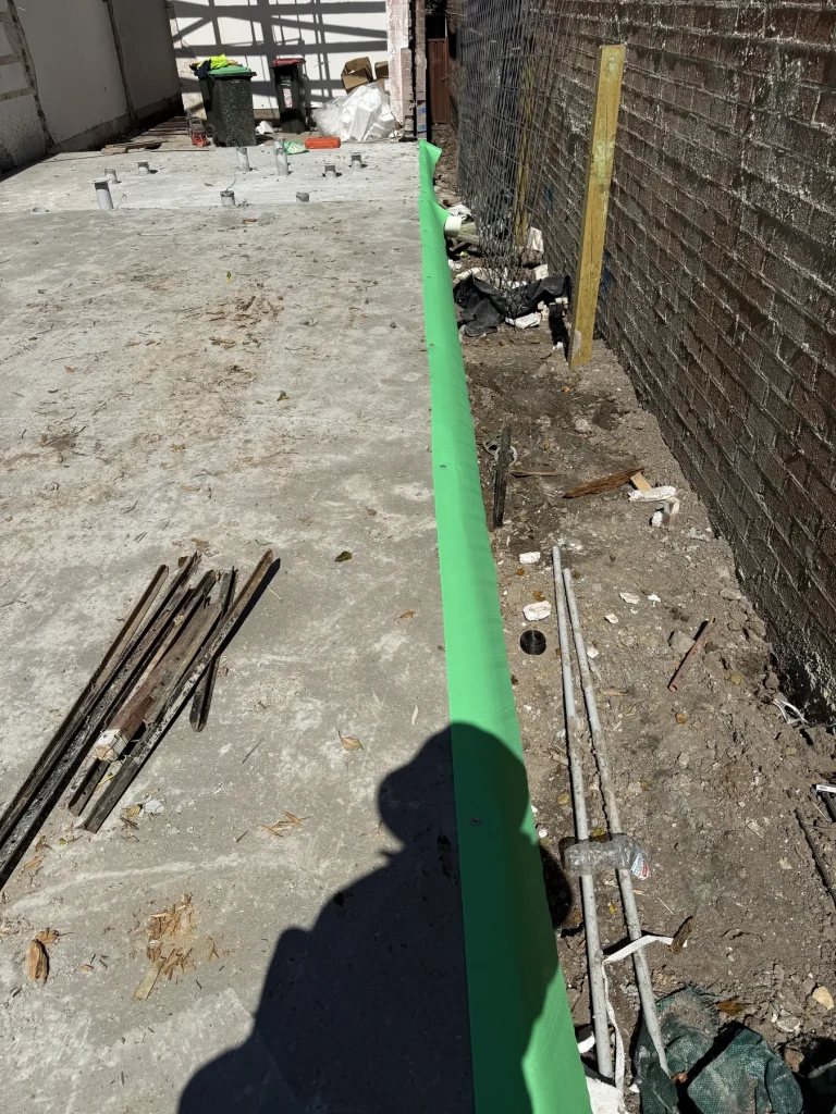 Termite protection installed along a construction perimeter edge
