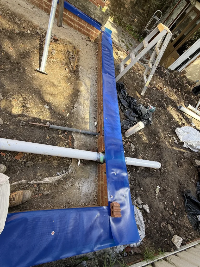 Physical termite barrier installed around a building corner