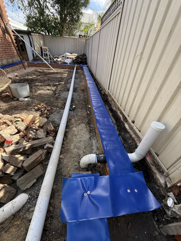 Termite barrier installation along an external construction perimeter