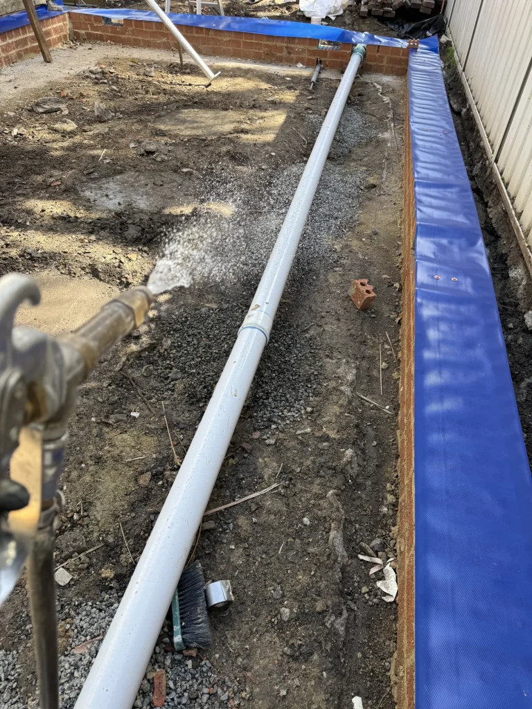 Termite protection installed along a building perimeter before completion